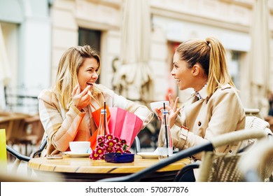 Two Women Have Fun After Shopping In Cafe