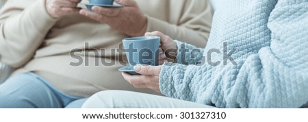 Similar – Image, Stock Photo woman having a cup of tea at home during breakfast. Cute golden retriever dog besides. Healthy breakfast with fruits and sweets. lifestyle indoors