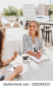 Two Women Having A Work Meeting Outside Coffee Shop