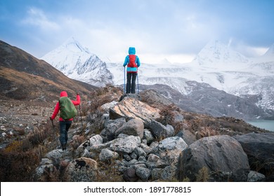 Two Women Hikers Hiking  In Winter Mountains