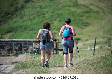 Two Women Hiking In The Mountains