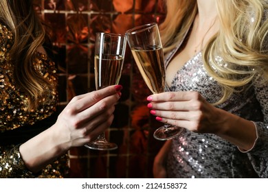 Two Women Are Holding Glasses Of Champagne At A Party Close Up