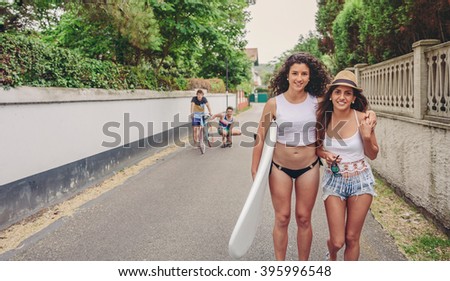 Similar – Happy young people walking along road in summer day