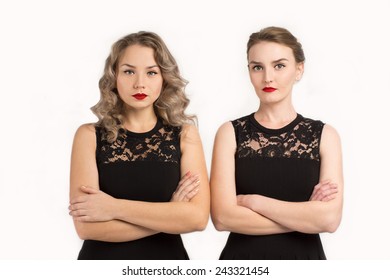 Two women in identical dresses are angry at each other/Two women in identical black dresses are angry at each other 