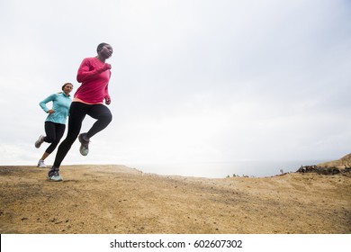 Two Women Jogging Along The Coast