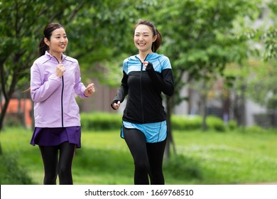 Two Women Jogging In The Park