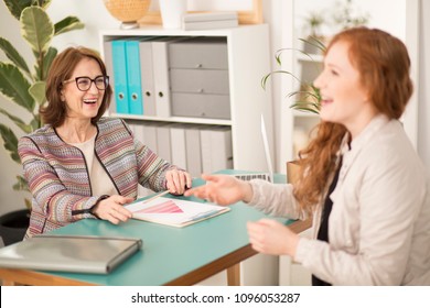 Two Women Laughing During A Job Interview In An Office