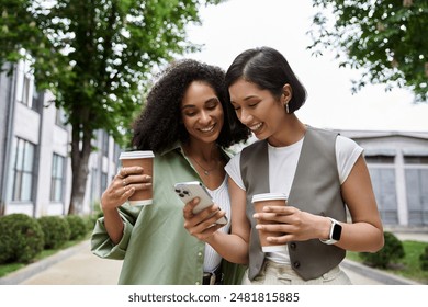 Two women, a lesbian couple, walk down a city street, smiling and looking at a phone together. - Powered by Shutterstock