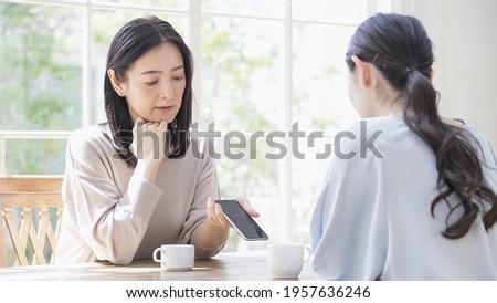 Two women looking at a smartphone