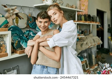Two women, a loving tender lesbian couple, hugging at an art studio. - Powered by Shutterstock