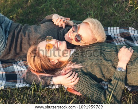 Two women are lying on the lawn . Best friends