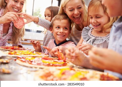 Two Women Making Pizza With Kids