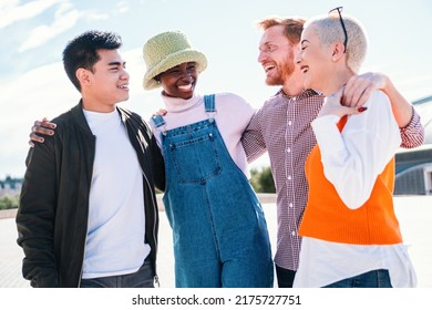 Two Women And Two Men At Park Talking Laughing And Enjoying Their Time. Friends Hanging Out And Talking Outdoors In Summer Park