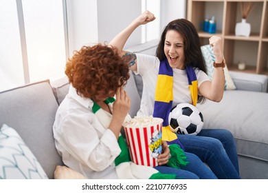 Two Women Mother And Daughter Supporting Soccer Match At Home