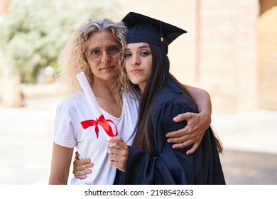 Two Women Mother And Graduated Daughter Hugging Each Other At Campus University