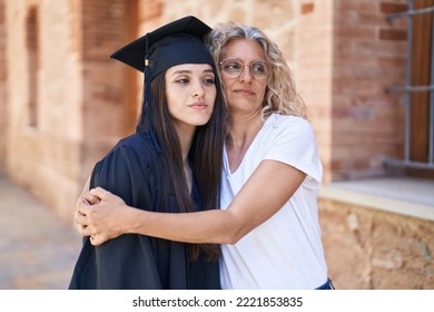 Two Women Mother And Graduated Daughter Hugging Each Other At Campus University