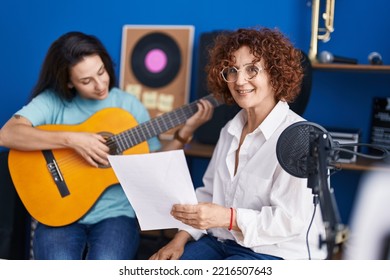 Two Women Musicians Having Classical Guitar Lesson At Music Studio