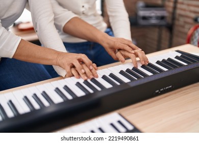 Two Women Musicians Having Piano Lesson At Music Studio