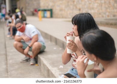 Two Women Notice A Nearby Creepy Man Staring At Them While At A Public Area. A Possible Stalker Creating An Uncomfortable Situation For Young Females.