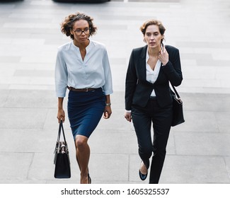 Two Women In Office Wear Stepping Up On Stairs In The City