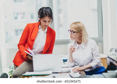 Two Women In Office Working In Front Of Computer