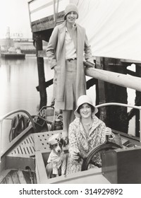 Two women out sailing with their mascot