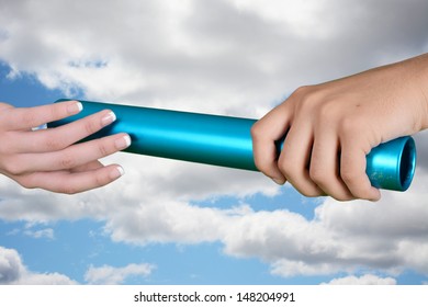 Two Women Passing A Baton In Relay Race