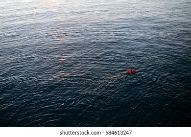 Two Women In Red Kayak Rowing In The Open Waters Of Mediterranean Sea, Near The Coast Of  Vernazza, Cinque Terre, Italy.