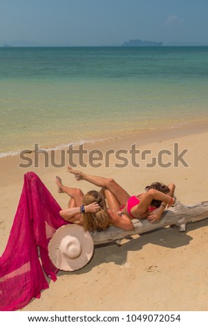 Two women relaxing at the  beach