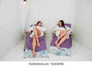 Two Women Relaxing In A Salt Cave At Halotherapy