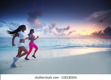 Two Women Running On Beach