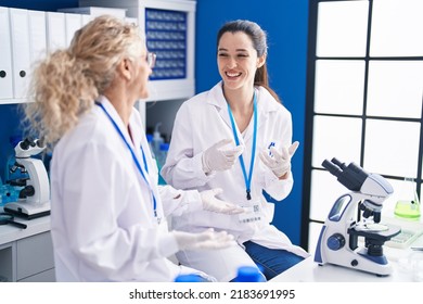 Two Women Scientists Smiling Confident Speaking At Laboratory