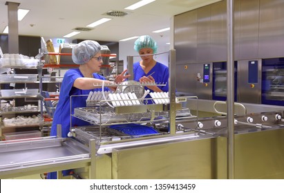 Two women are seen working as medical hygiene 
technicians. They are dressed in special medical 
hygiene clothing. They are seen carrying out hygiene 
disinfecting and sterilization tasks.