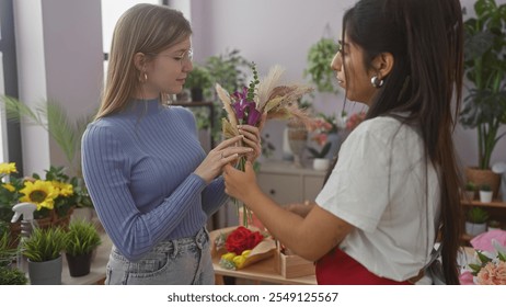 Two women selecting flowers in a bright indoor flower shop. - Powered by Shutterstock