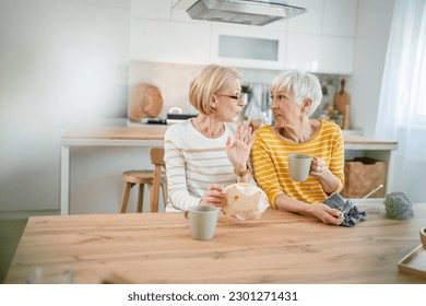 two women senior mature caucasian friends or mother and daughter or sisters knitting and embroidery during leisure time at home needlework concept bright photo happy and relaxed enjoy free time