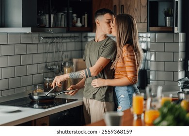 Two women are sharing a tender kiss while preparing a meal together in their contemporary kitchen, showcasing love, domesticity, and lgbtq plus representation - Powered by Shutterstock