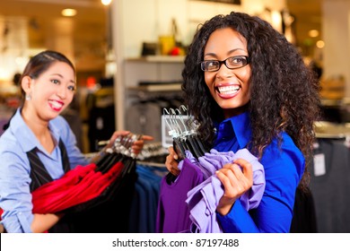 Two Women In A Shopping Mall Downtown Looking For Clothes