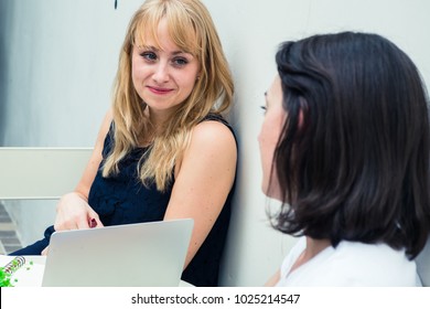 Two Women Sit Smiling Talking Planning Stock Photo (Edit Now) 1025214547