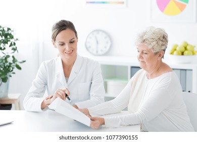 Two women sitting in a dietician's office and talking about a new diet plan. Healthy living concept - Shutterstock ID 1077390155