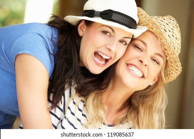 Two Women Sitting Outside House