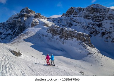 Two Women Skiing In The Canadian Rocky Mountains, Near Banff, Alberta