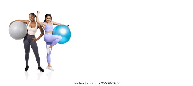 Two women smile while holding large exercise balls in a bright gym environment. They wear activewear and showcase a strong sense of fitness and camaraderie during their workout session. - Powered by Shutterstock