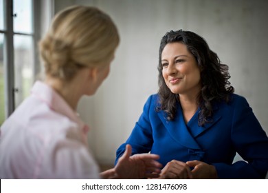 Two Women Smiling And Talking