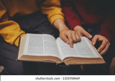 Two women studying the bible. - Shutterstock ID 1101958469