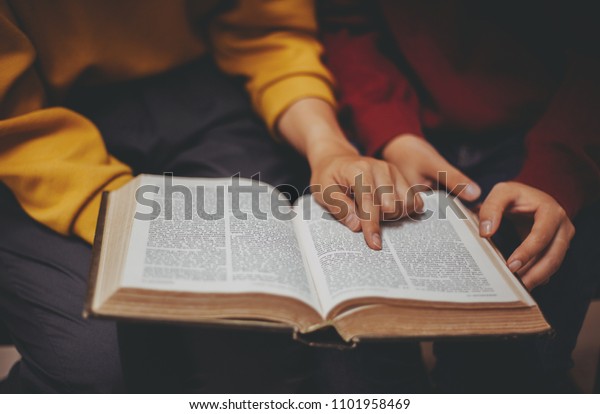 Two women studying the\
bible.