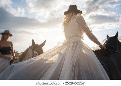 Two Women in Stylish Outfits Riding Horses Across Sunlit Field. - Powered by Shutterstock