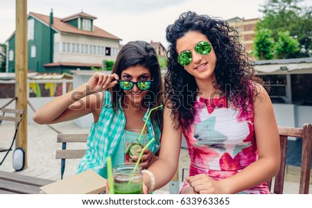 Similar – Smiling young woman looking at camera over sunglasses