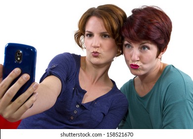 two women taking self portraits with a cell phone
