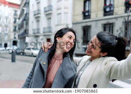 Similar – Image, Stock Photo two sisters laugh heartily on the street