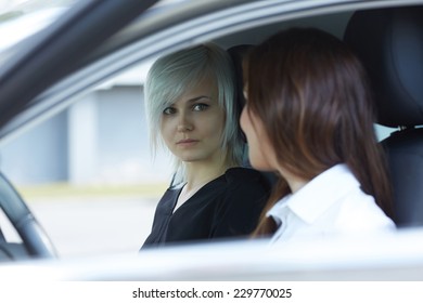 Two Women Talking In The Car 